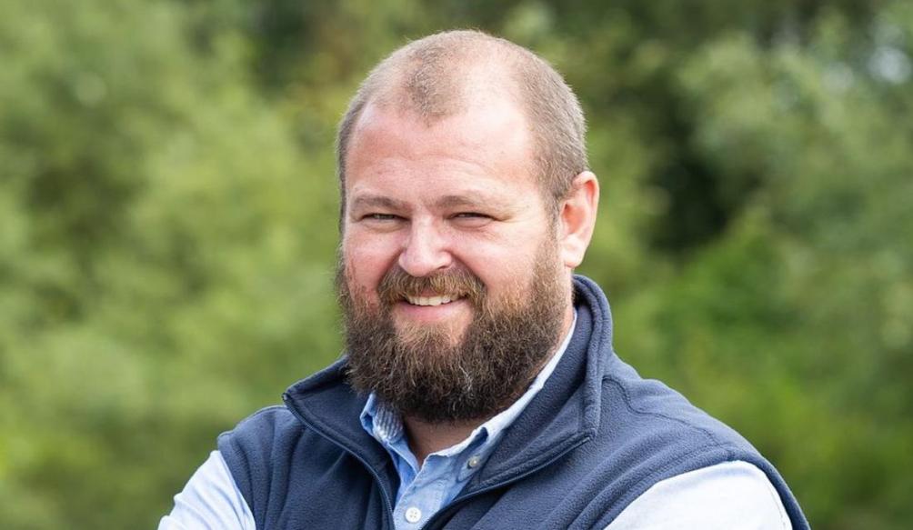 Adam Godwin stood smiling